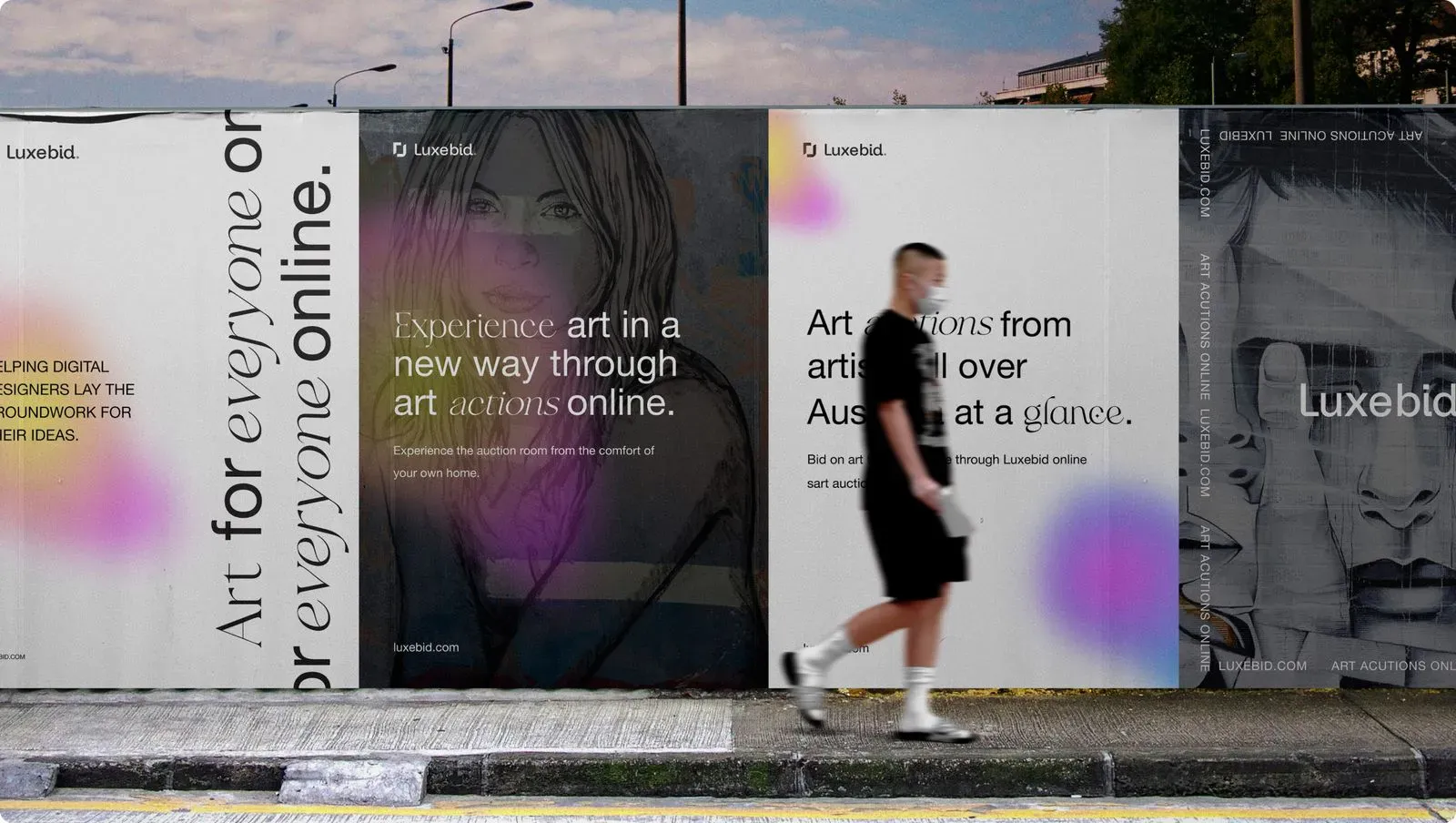 Luxebid posters on a street hoarding